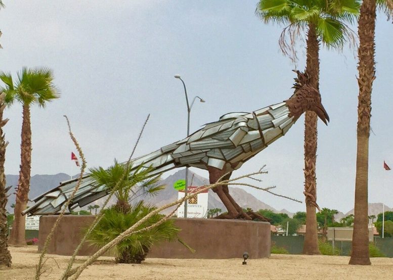 Roadrunner metal structure surrounded by palm trees